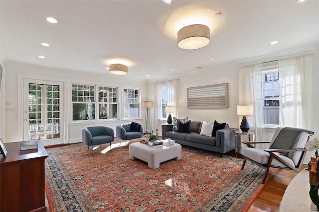 living room with ornamental molding and hardwood / wood-style floors