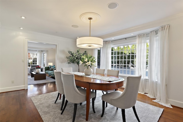 dining room with ornamental molding, dark hardwood / wood-style flooring, and plenty of natural light