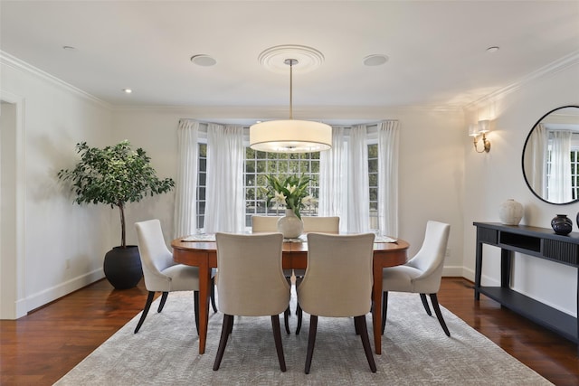 dining space featuring ornamental molding and dark hardwood / wood-style flooring