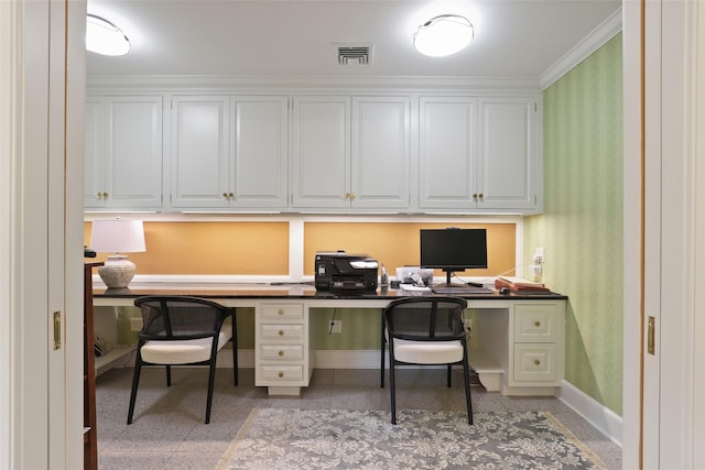 office area with built in desk and crown molding