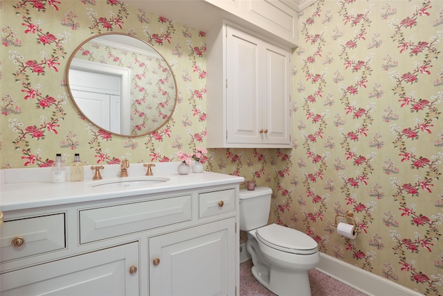 bathroom featuring toilet and vanity