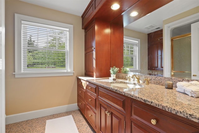 bathroom with an enclosed shower and vanity