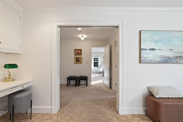 corridor featuring light colored carpet and ornamental molding