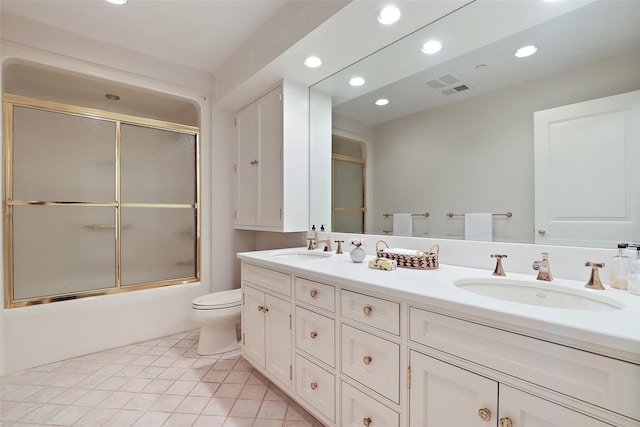 full bathroom with toilet, tile patterned flooring, vanity, and bath / shower combo with glass door