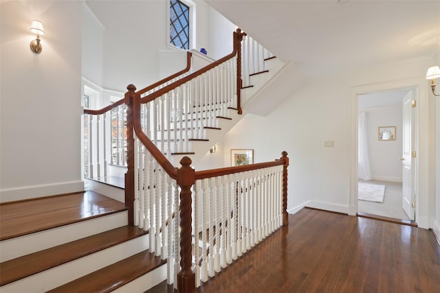 staircase featuring wood-type flooring and crown molding