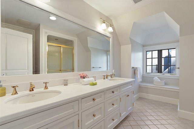 bathroom with walk in shower, vanity, and tile patterned floors