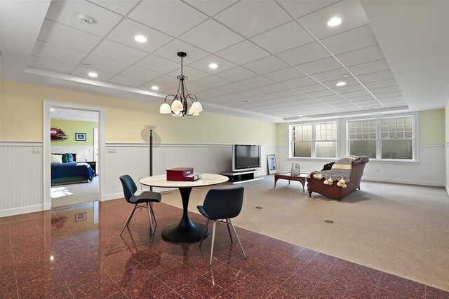 dining space with a notable chandelier and carpet