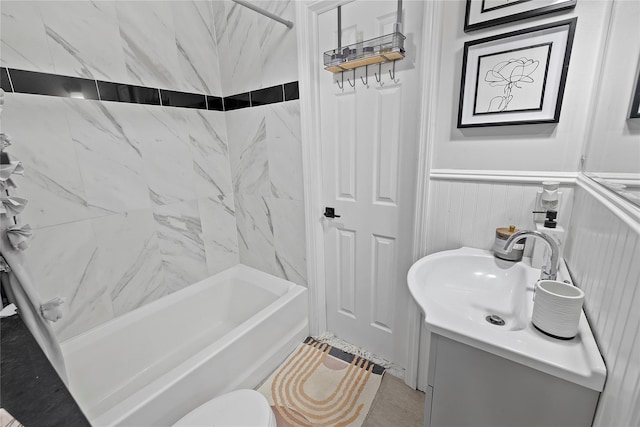 full bathroom featuring toilet, tile patterned floors, vanity, and tiled shower / bath