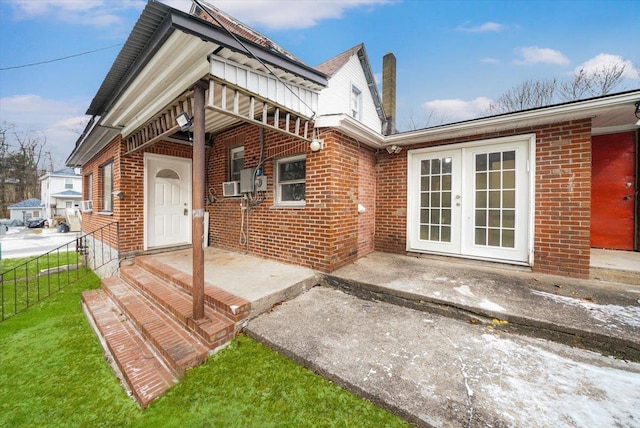 rear view of property featuring cooling unit and french doors