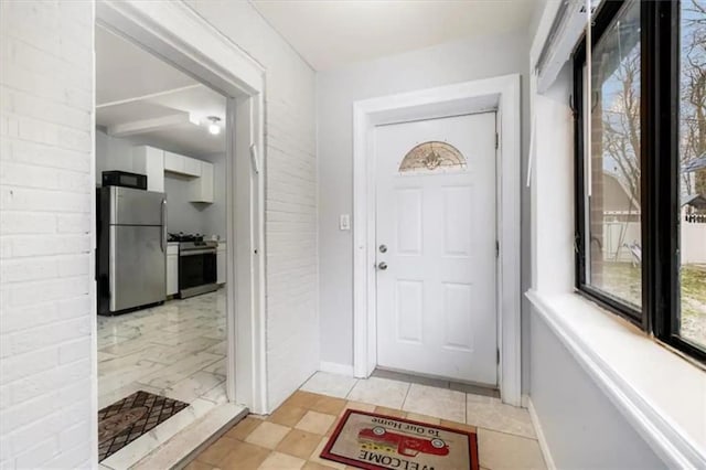 doorway featuring brick wall