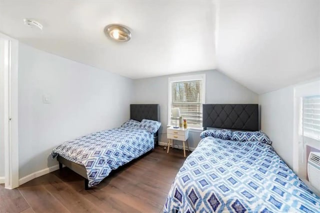 bedroom with lofted ceiling and dark hardwood / wood-style floors