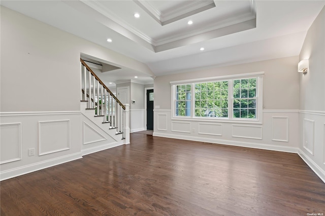 unfurnished living room featuring ornamental molding, dark hardwood / wood-style flooring, and a raised ceiling