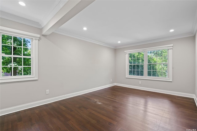 spare room featuring beam ceiling, crown molding, and dark hardwood / wood-style floors