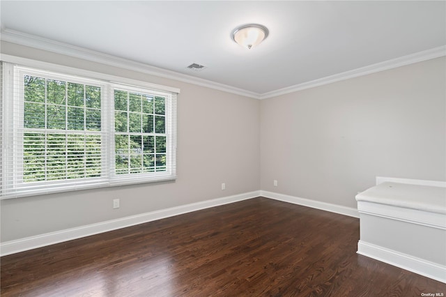 spare room with dark wood-type flooring and ornamental molding