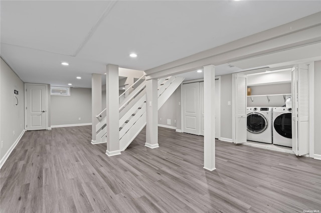 basement with independent washer and dryer and light hardwood / wood-style floors