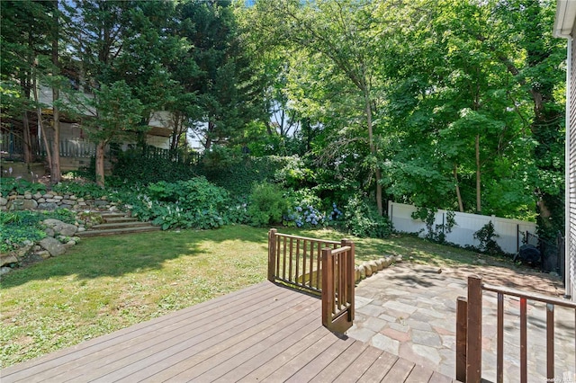 wooden terrace featuring a lawn