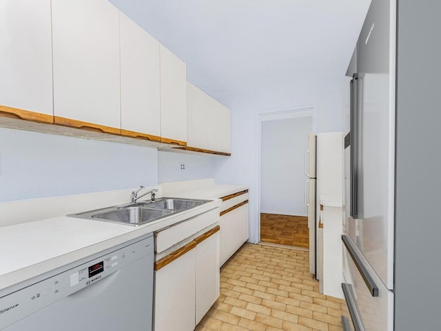 kitchen with white cabinetry, high quality fridge, and dishwasher