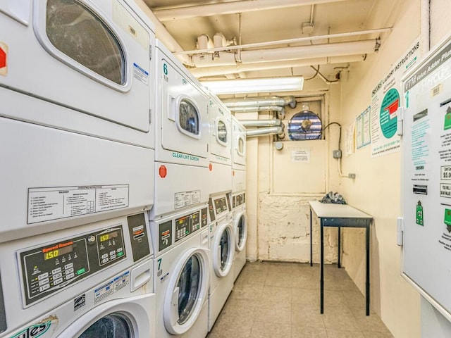 washroom with stacked washer and clothes dryer and washer and clothes dryer