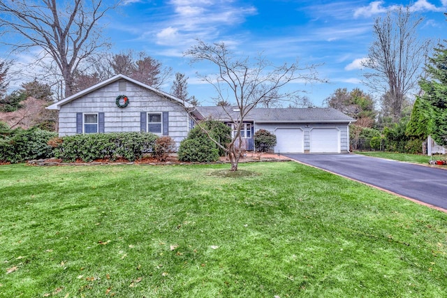 single story home featuring a garage and a front yard