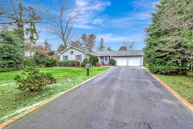 single story home with a garage and a front lawn