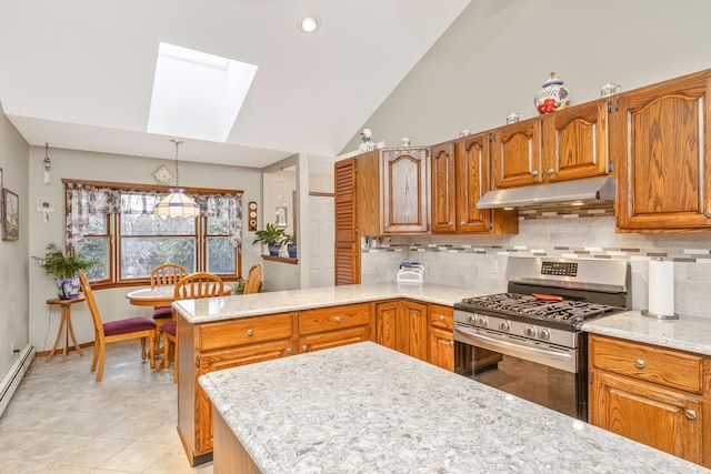 kitchen featuring decorative light fixtures, a skylight, tasteful backsplash, high vaulted ceiling, and stainless steel range with gas stovetop