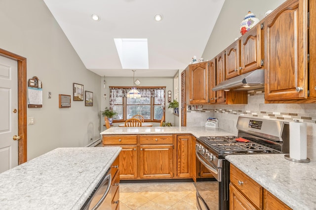 kitchen with decorative light fixtures, backsplash, appliances with stainless steel finishes, and lofted ceiling with skylight