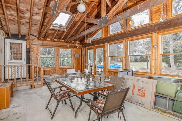 sunroom featuring vaulted ceiling with skylight