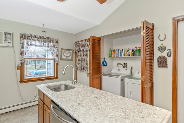 laundry area featuring separate washer and dryer, ceiling fan, baseboard heating, and sink