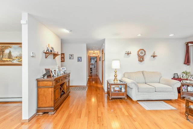 living room featuring light wood-type flooring and a baseboard radiator