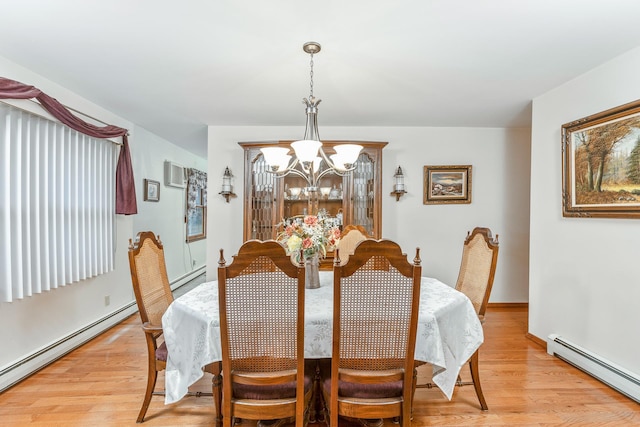 dining room featuring a baseboard heating unit, a notable chandelier, and light hardwood / wood-style flooring