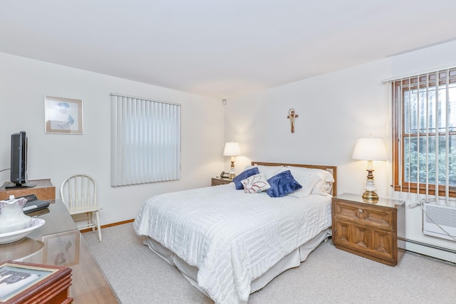 bedroom featuring light carpet and baseboard heating