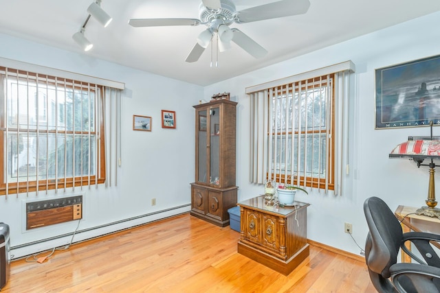 office area featuring hardwood / wood-style flooring, baseboard heating, and plenty of natural light