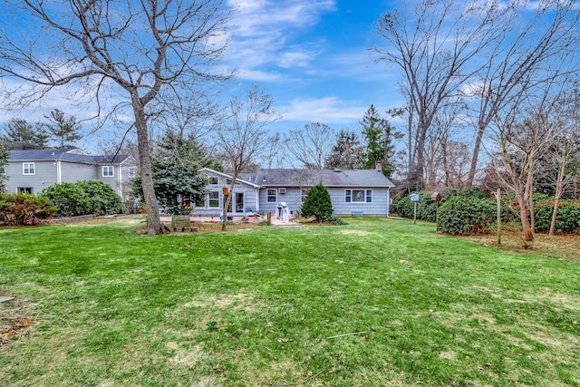 back of house with a lawn