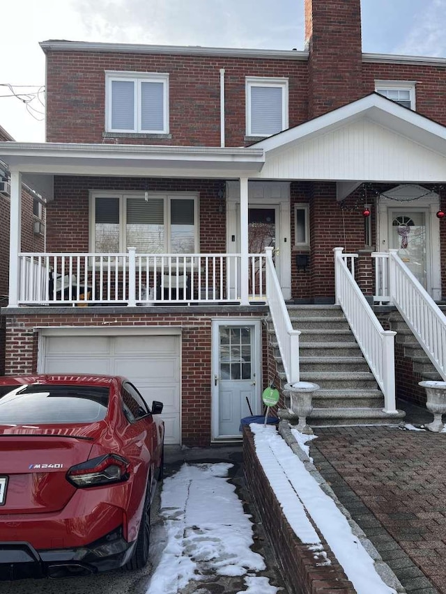 multi unit property with covered porch and a garage