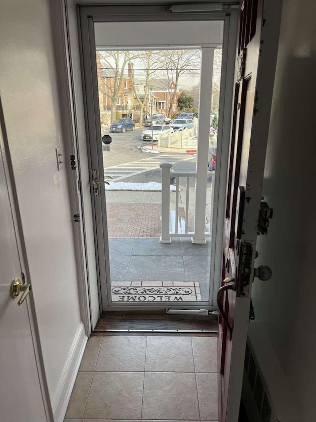 doorway featuring light tile patterned floors and plenty of natural light