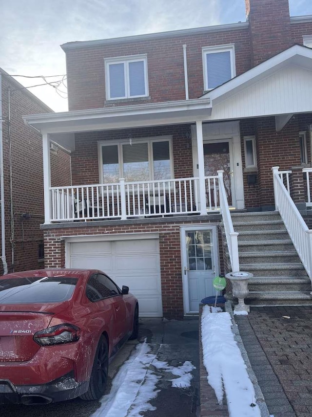 multi unit property featuring a garage and covered porch