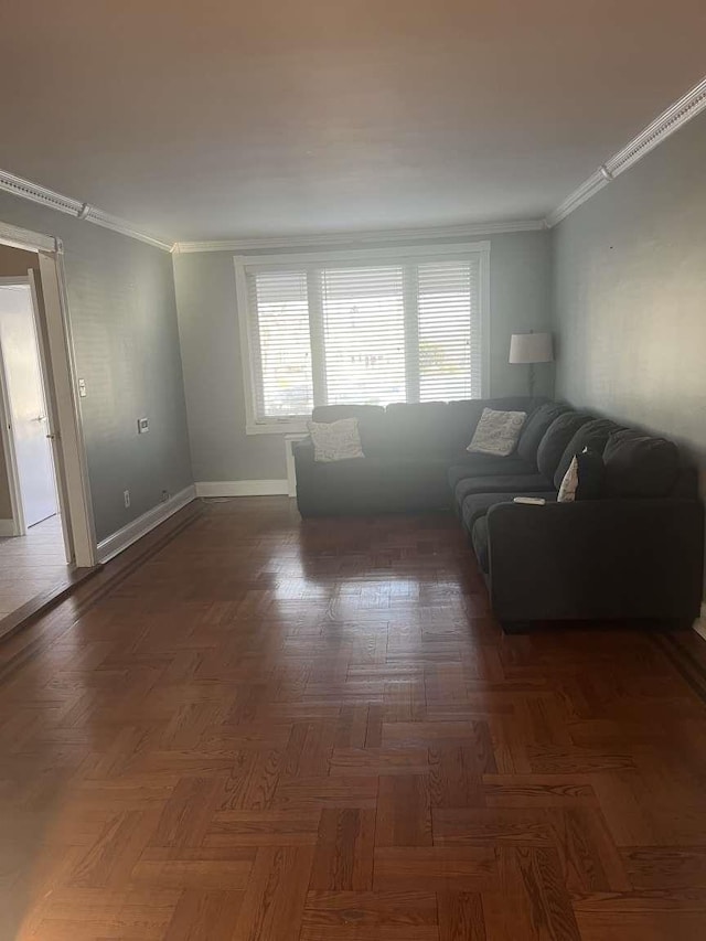 unfurnished living room featuring crown molding and dark parquet floors