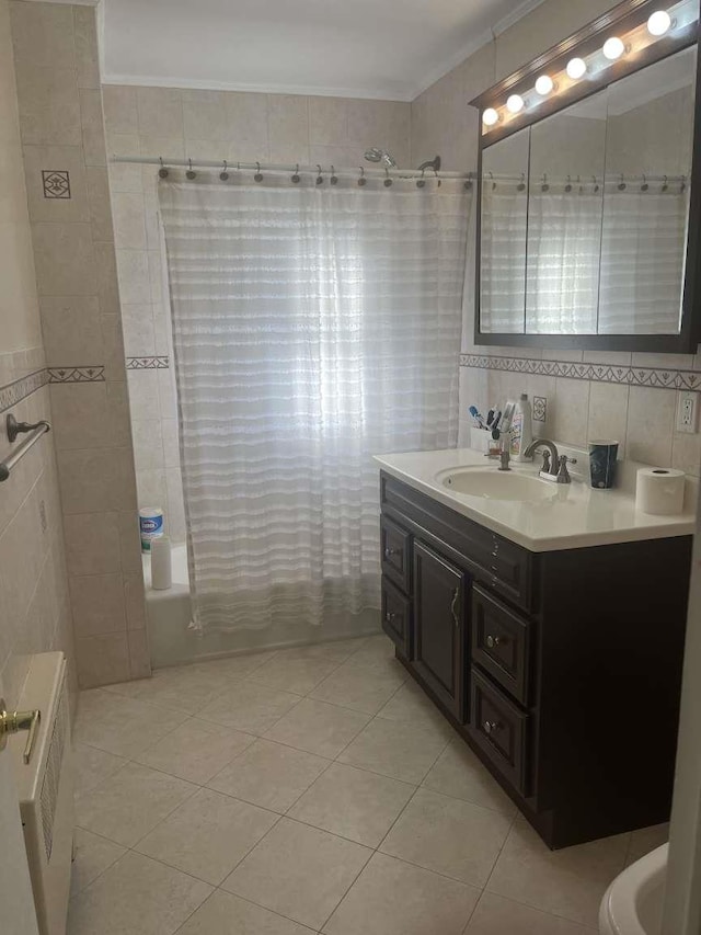 bathroom with tile walls, vanity, tile patterned flooring, and shower / bath combo