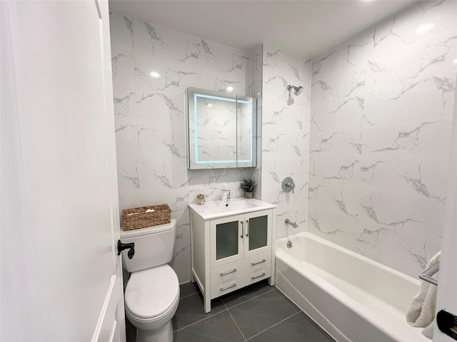 full bathroom with tile walls, tile patterned flooring, vanity, toilet, and washtub / shower combination