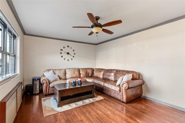 living room featuring ornamental molding, ceiling fan, a healthy amount of sunlight, and wood-type flooring