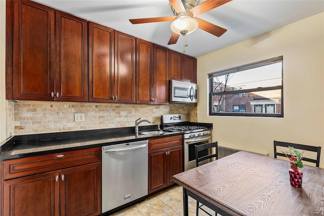 kitchen featuring stainless steel appliances, sink, ceiling fan, and tasteful backsplash