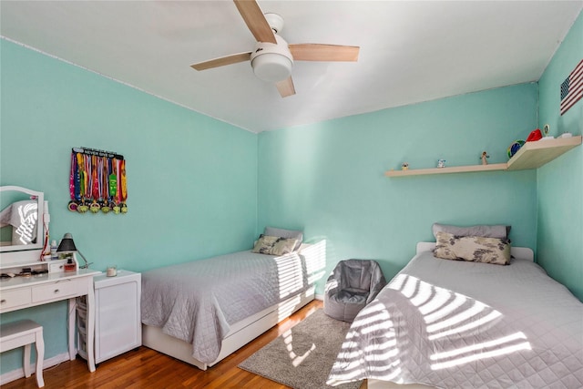 bedroom with ceiling fan and hardwood / wood-style flooring