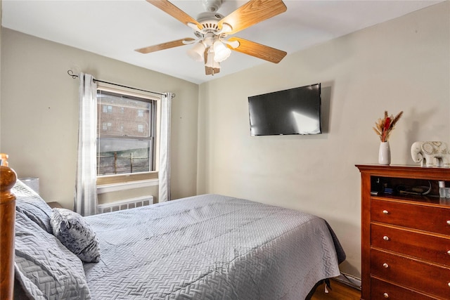 bedroom with hardwood / wood-style floors and ceiling fan