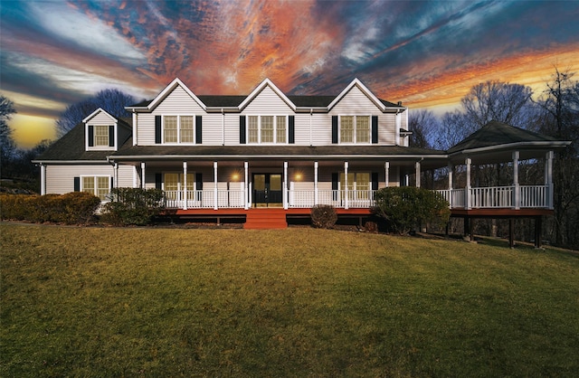 view of front facade featuring a porch and a yard