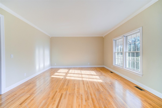 unfurnished room featuring crown molding and light wood-type flooring