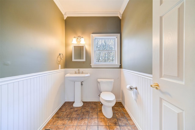 bathroom with toilet and crown molding