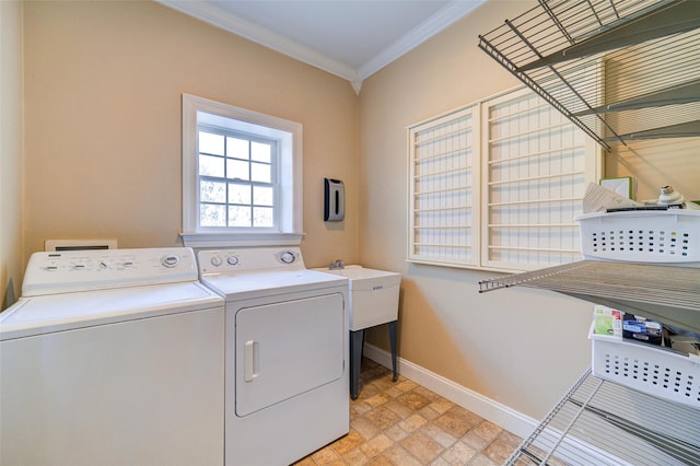 clothes washing area featuring washing machine and clothes dryer and ornamental molding