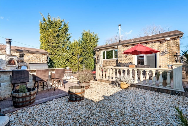 view of yard featuring exterior bar, a fireplace, and a patio area