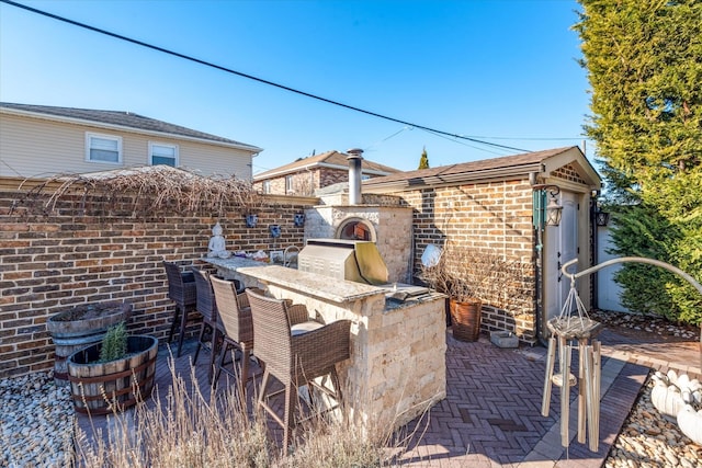 view of patio / terrace with an outdoor bar, area for grilling, and grilling area