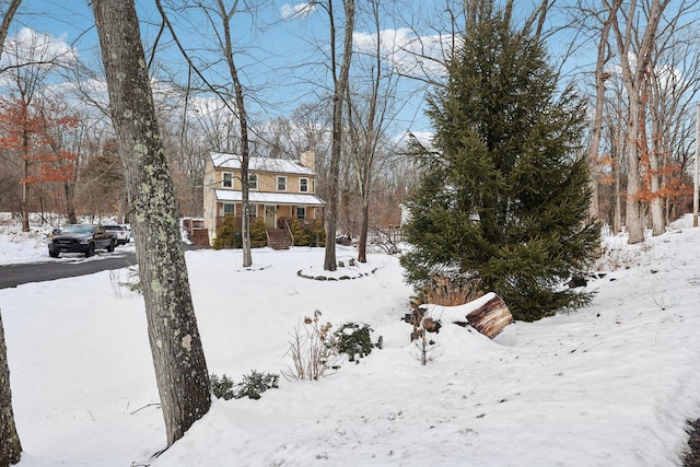 snowy yard with covered porch